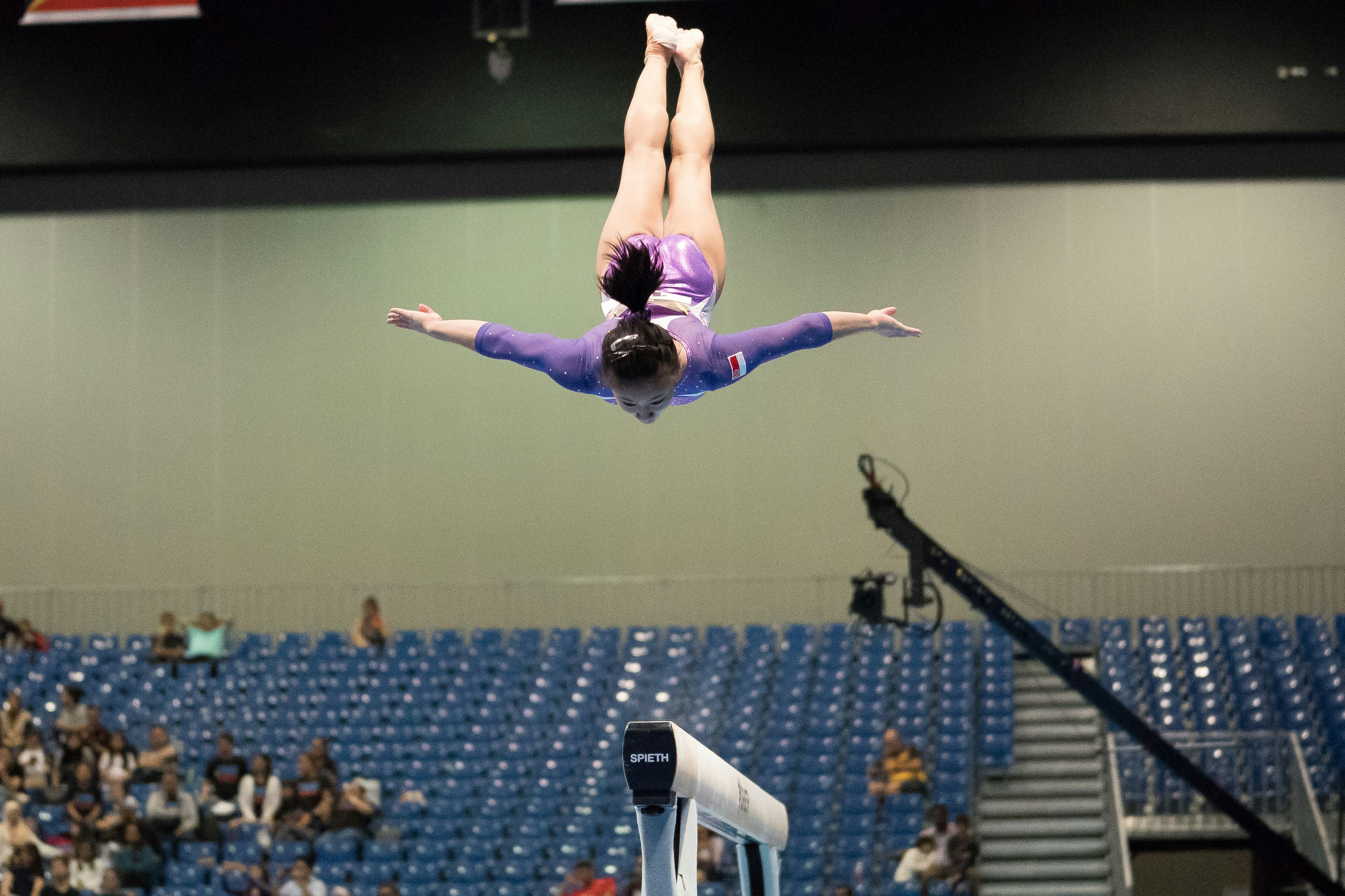 Gymnast preforming on a balance beam